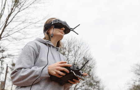 LVIV, UKRAINE - Feb. 11, 2024: A young woman is seen wearing virtual reality goggles and a remote...