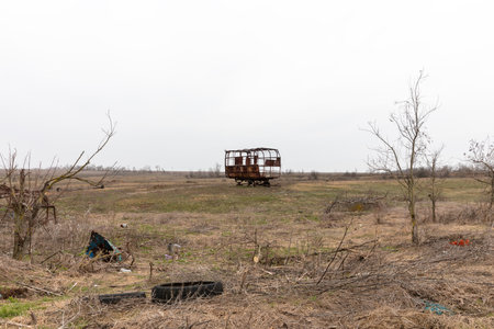 MYKOLAIV Reg, UKRAINE - Mar. 02, 2024: War in Ukraine. A hay trailer is completely burnt out in the...