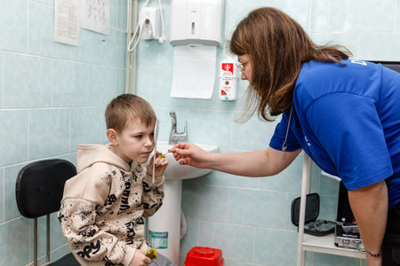 DONETSK Reg, UKRAINE - Apr. 20, 2024: An ophthalmologist from the Frida Volunteer Mission is seen checking a child's eyesightのeditorial素材