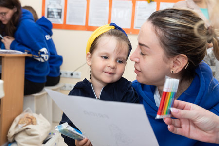 DONETSK Reg, UKRAINE - Apr. 21, 2024: A woman doctor from Frida Volunteer Mission is seen talking to the childのeditorial素材