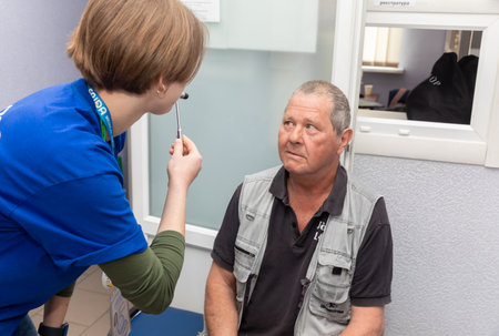 DONETSK Reg, UKRAINE - Apr. 20, 2024: A doctor from Frida Volunteer Mission is seen performing an initial examination of an elderly manのeditorial素材