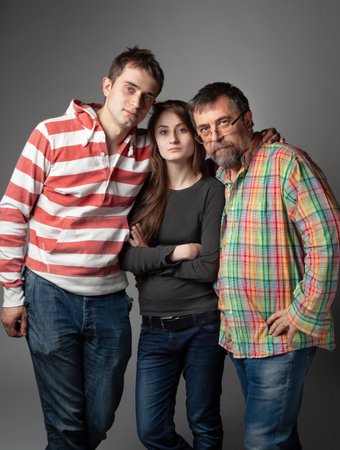 Family portrait of father, son and daughter in studio
