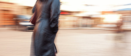 A lonely girl going about her business. City life in a motion blurred style.の写真素材