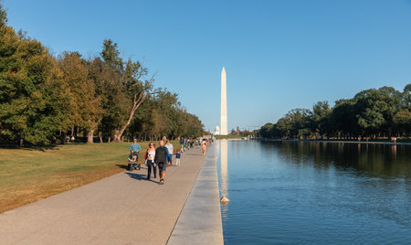 Washington DC, USA - Oct. 10, 2022: People relaxing in front of a scenic view of the Washington Monument and surrounding park, captured on a beautiful day.のeditorial素材