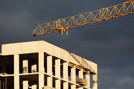 Construction boom in western Ukraine. Sunset light highlights cranes and buildings in a city under development.の写真素材