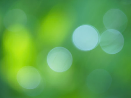 Abstract background with soft hues of green and blue in a blurred composition, evoking a sense of calmness and connection to nature. Light filters through leaves, creating a peaceful ambiance.の写真素材