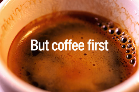 A close up view of a warm cup containing dark, aromatic coffee. The rich brew is inviting and...
