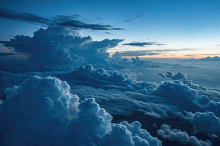 During twilight, an aerial view reveals glowing stratocumulus clouds illuminated by the fading...