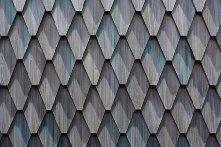 An eye level, close up shot of a textured wooden wall made of diamond shapes. The material is weathered and has interesting shadow details.の写真素材