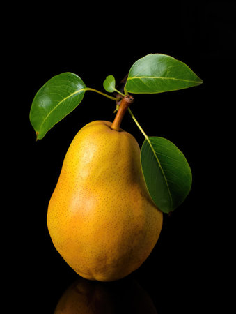 A vibrant close up of a ripe pear with green leaves, set against a stark black background,...