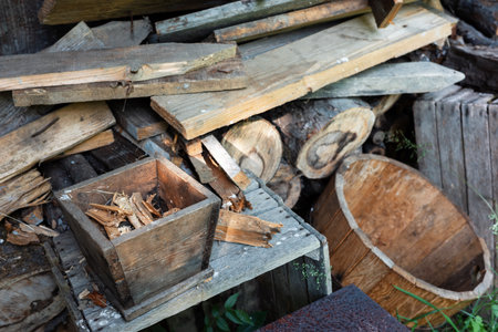 Close up shot of wooden objects like planks, logs, and a wooden box filled with wood chips,...