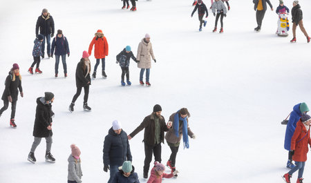 KYIV, UKRAINE - Dec. 27, 2020: Ice-skating people. People have fun in ice arena at the city ice rink. New Years holidays in city Kyiv.の写真素材