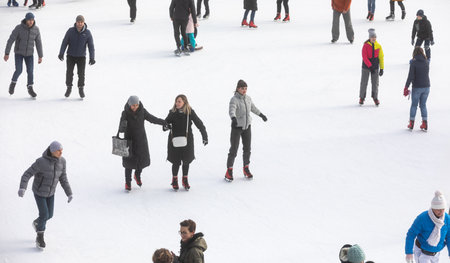KYIV, UKRAINE - Dec. 27, 2020: Ice-skating people. People have fun in ice arena at the city ice...