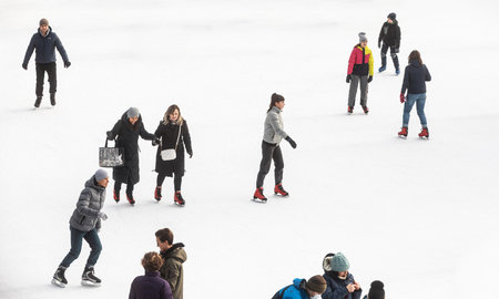 KYIV, UKRAINE - Dec. 27, 2020: Ice-skating people. People have fun in ice arena at the city ice rink. New Years holidays in city Kyiv.の写真素材