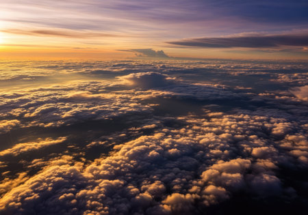 The sun's rays illuminate the clouds from above, creating a breathtaking display of color and lightの写真素材