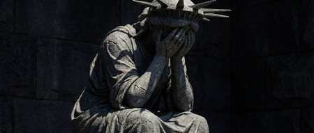 A stone statue resembling a figure is seated, covering its face with hands in a gesture of sorrow.の写真素材