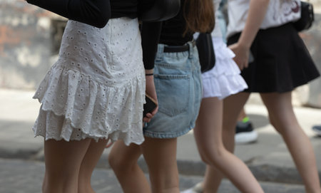 Lviv, Ukraine - May 24, 2026: Pedestrians walking through Lviv Ukraine streets navigate the urban pavement while wearing casual summer clothing during a daily commute in the city.