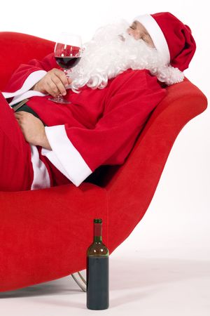 Santa Claus relaxing with a glass of red wineの写真素材