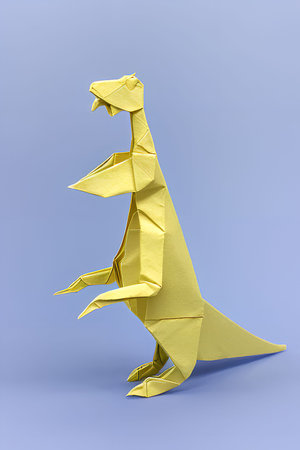 Paper origami dinosaur isolated on blue background. 3d illustration.の写真素材