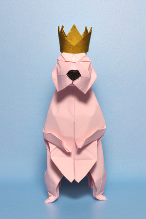Paper origami dog with golden crown on blue background. 3D rendering.の写真素材