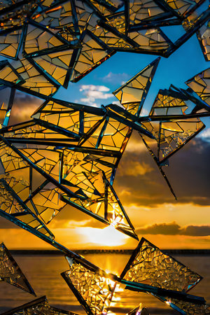 abstract of broken glass with beautiful sky and sea at sunset.の写真素材
