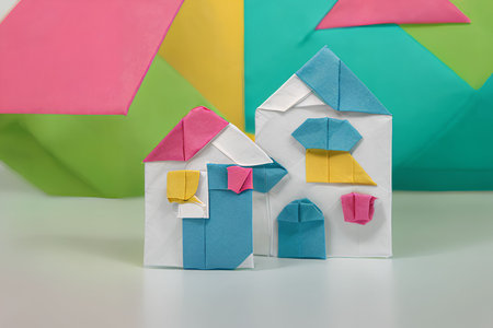 Origami paper house on a colorful background. The concept of home and family.の写真素材