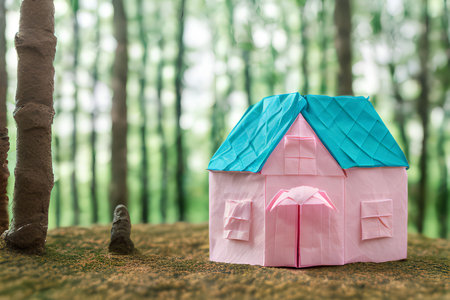 Miniature house in the forest with bokeh background. Eco friendly concept.の写真素材