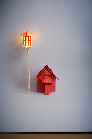 Paper house and lantern on white wall background. Minimal concept.の写真素材
