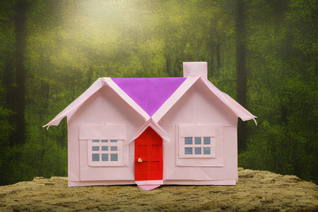 Paper house in the forest with bokeh background, concept of real estateの写真素材