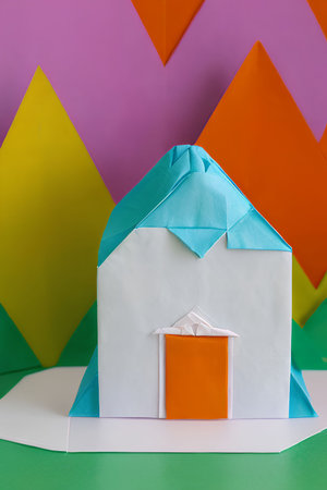 Paper house with origami house on colorful background. Minimal concept.の写真素材