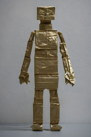 Gold robot made of gold foil on a white background. 3d renderingの写真素材
