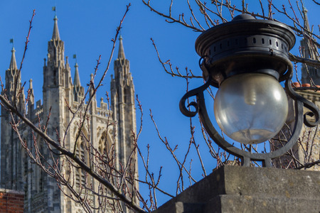 Street lamp and tree branches with Canterbury Cathedral in the background phoographed in March 2016 in Canterbury, UKの写真素材