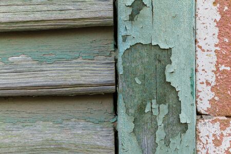 Cyan peeling paint window wood planks and pink brick wall shot with a shallow depth of field in old Nicosia, Cyprusの写真素材