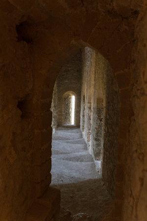 Atmospheric view inside a medieval castle corridor with daylight entering in onedirection and sidewaysのeditorial素材