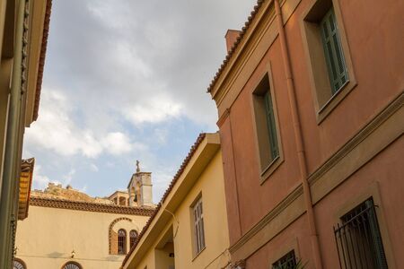Plaka district in Athens Greece, with Church and the Acropolis in the backgroundの写真素材