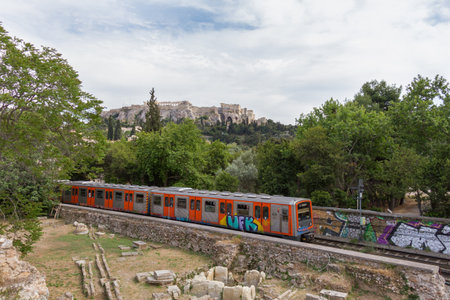 Passing train through Athens Ancient Agora with Acropolis in the background. Photo taken in spring 2016のeditorial素材
