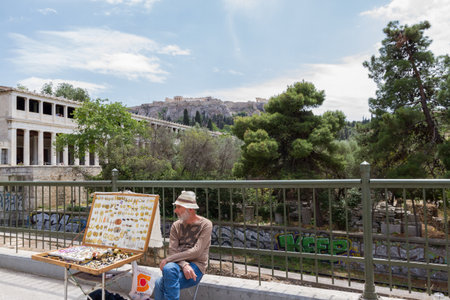 Athens, Greece - April 30, 2016: Street vendor selling jewellery near Stoa of Attalos of the Ancient Agora of Athens with the Acropolis in the background.のeditorial素材