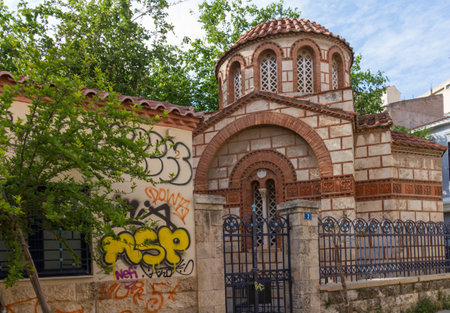 Athens, Greece - April 30, 2016: Church Agia Paraskevi Agioi Anargyroi and graffitti in Psirri neighborhood in Athens.のeditorial素材