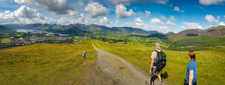 Keswick, United Kingdom - 13 August, 2017: People hiking in Latrigg hill overlooking Keswick and lake Derwent Water, Cumbria, UKのeditorial素材
