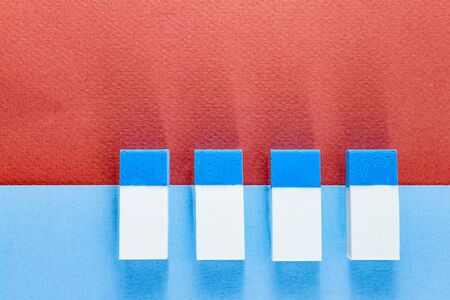 Top view of blue and white erasers on blue and brown color papers background in landscapeの写真素材