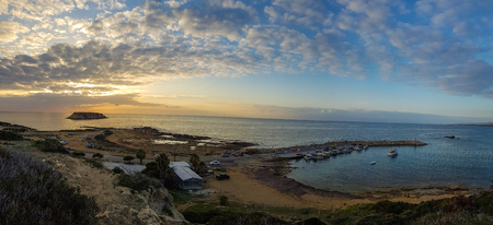 Wide panorama of a sunset at Agios Georgios Pegeias Fishing harbor in Paphos, Cyprusの写真素材