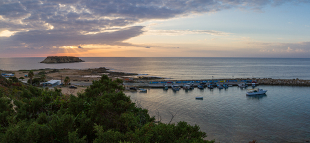 Panorama of a sunset at Agios Georgios Pegeias Fishing harbor in Paphos, Cyprusの写真素材
