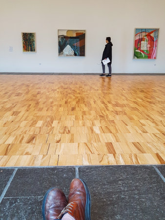 Newcastle, England - March 11, 2018: A visitor is looking at paintings inside the Whitworth Art...