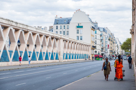 Paris, France - August 8, 2018: People walking along a bridge on rue Lafayette, above the railways of gare de l'Estのeditorial素材