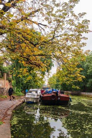 London, England - August 9, 2018: Man walking his dog along Islington Canal in Angel, London.のeditorial素材