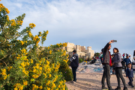 Athens, Greece - March 9, 2019: Tourists take selfies on Areopagus Hill against the Acropolis of Athens in the backgroundのeditorial素材