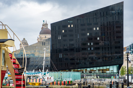 Liverpool, United Kingdom - April 26, 2019: Modern and classic architecture at the Liverpool Docks, Port of Liverpool, late on a cloudy afternoonのeditorial素材