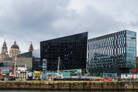 Liverpool, United Kingdom - April 26, 2019: Modern and classic architecture at the Liverpool Docks, Port of Liverpool, late on a cloudy afternoonのeditorial素材