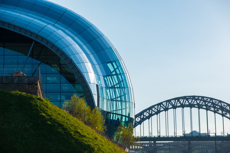 Newcastle, United Kingdom - April 29, 2019: View of the Sage Gateshead and Tyne Bridge against Newcastle cityscape.のeditorial素材