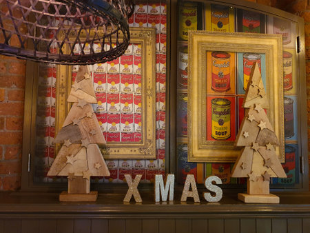 Liverpool, United Kingdom - November 24, 2019: Shop window with festive Christmas Decor comprising two wooden Christma Trees and glittering letters arranged as XMASのeditorial素材